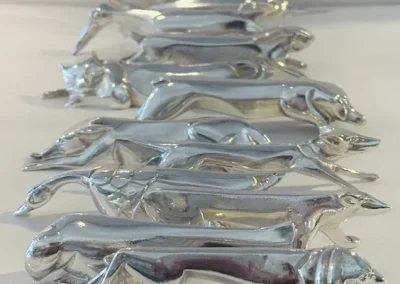 12 porte-couteaux, art-déco, signés Gallia, designer Edouard- Marcel Sandoz.